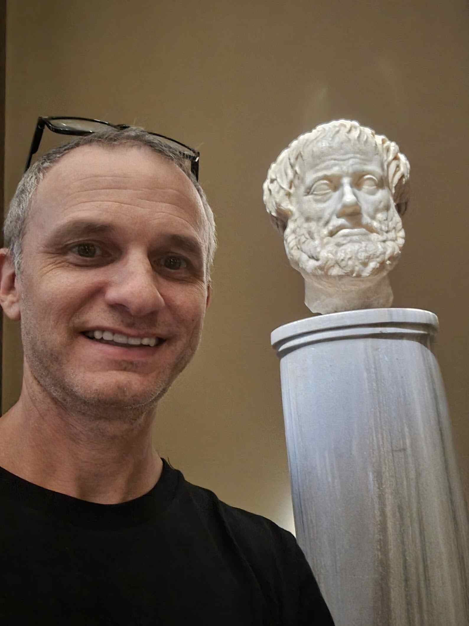 Adam with Aristotle statue